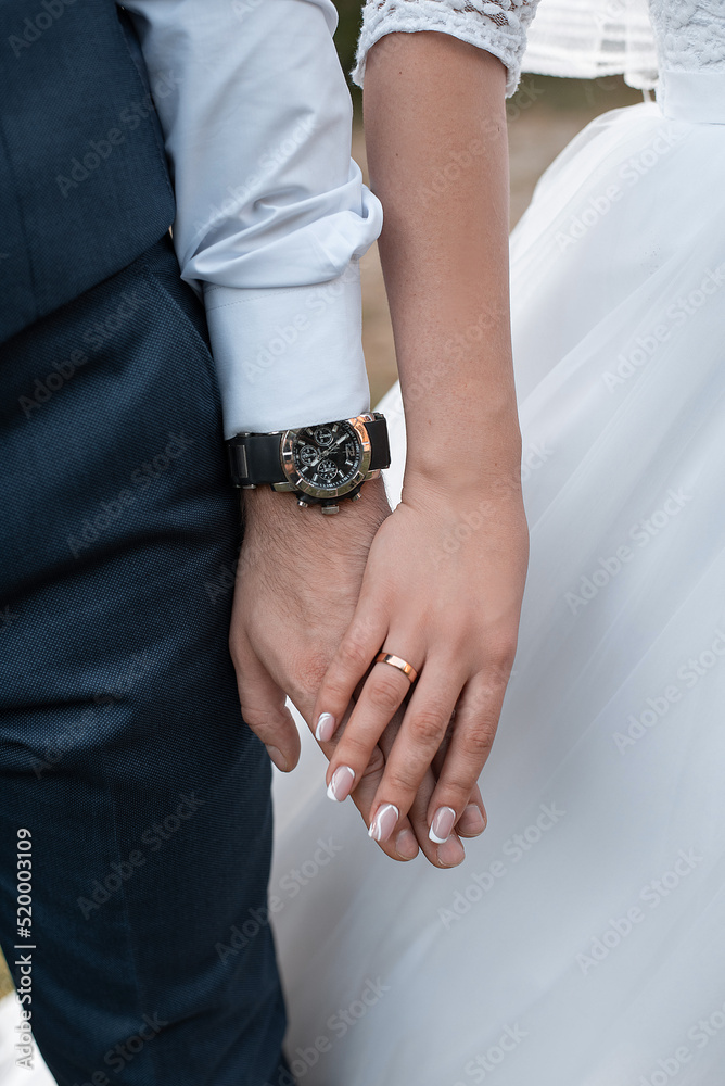 hands of the bride and groom with wedding rings at the ceremony