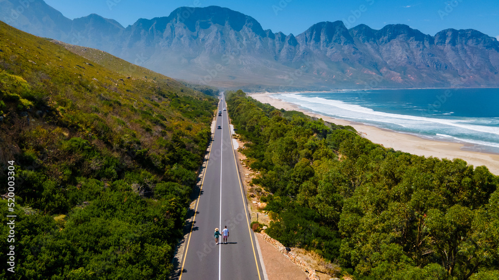 Naklejka premium Kogelbay beach Western Cape South Africa, Kogelbay Rugged Coast Line with spectacular mountains. Garden route, drone aerial view at the road and beach