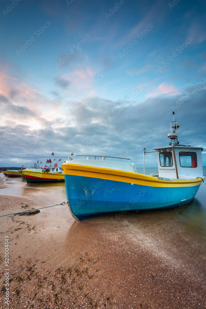 Beautiful sunset with fishing boats at the beach of Baltic Sea in Sopot, Poland