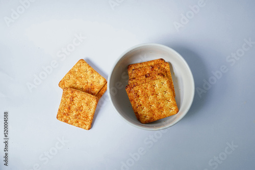 delicious snack, cracker biscuits in a bowl on a white background
