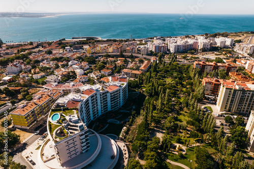 Lisbon, Portugal - July 29, 2022: Aerial drone view of luxury condominium next to Parque dos Poetas in Oerias, translated to Poet's Park