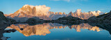 The panorama of Mont Blanc massif Les Aiguilles towers, Grand Jorasses and Aiguille du Verte over the Lac Blanc lake in the sunset light.