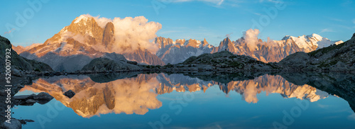 Fototapeta Naklejka Na Ścianę i Meble -  The panorama of Mont Blanc massif  Les Aiguilles towers, Grand Jorasses and Aiguille du Verte over the Lac Blanc lake in the sunset light.