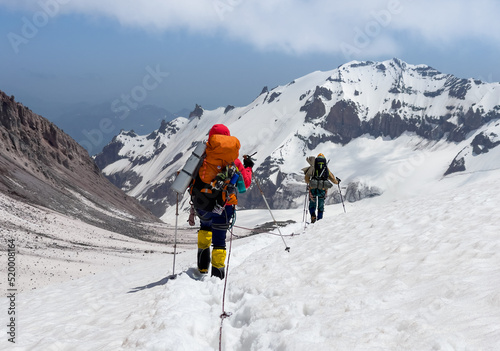 Fotografija Mountaineers rope descending Kazbek 5054m mountain with backpacks after successf