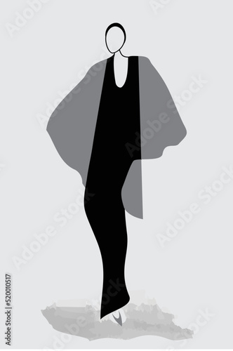 A stylishly dressed woman strikes a high fashion pose.