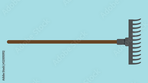 Fotografie, Obraz rake with wooden handle on blue background