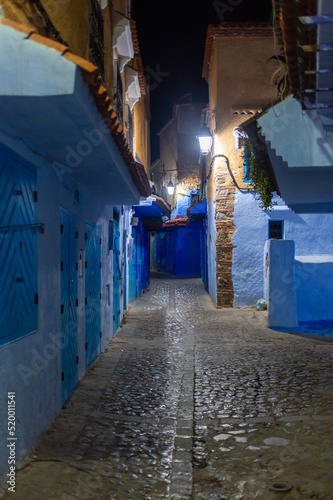 Chefchaouen, Morocco - 17 January 2022 : Alleys of the blue city Chefchaouen by night © Oualid