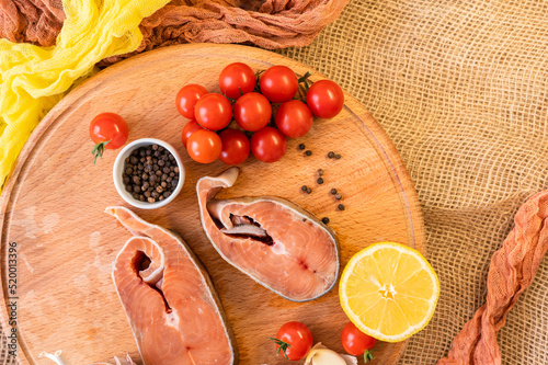  Raw red fish steaks on a wooden cutting board, ingredients for cooking. High quality photo