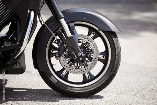 motorbike Front wheel and shock absorber close-up, outdoor on street. bike riding. Sport rock lifestyle transport. Close up front wheel of a motorcycle.. Enjoying of freedom¨, power and local tourism