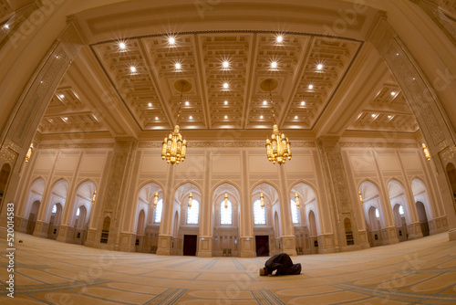  A man prays at the Sultan Qaboos Mosque in Nizwa