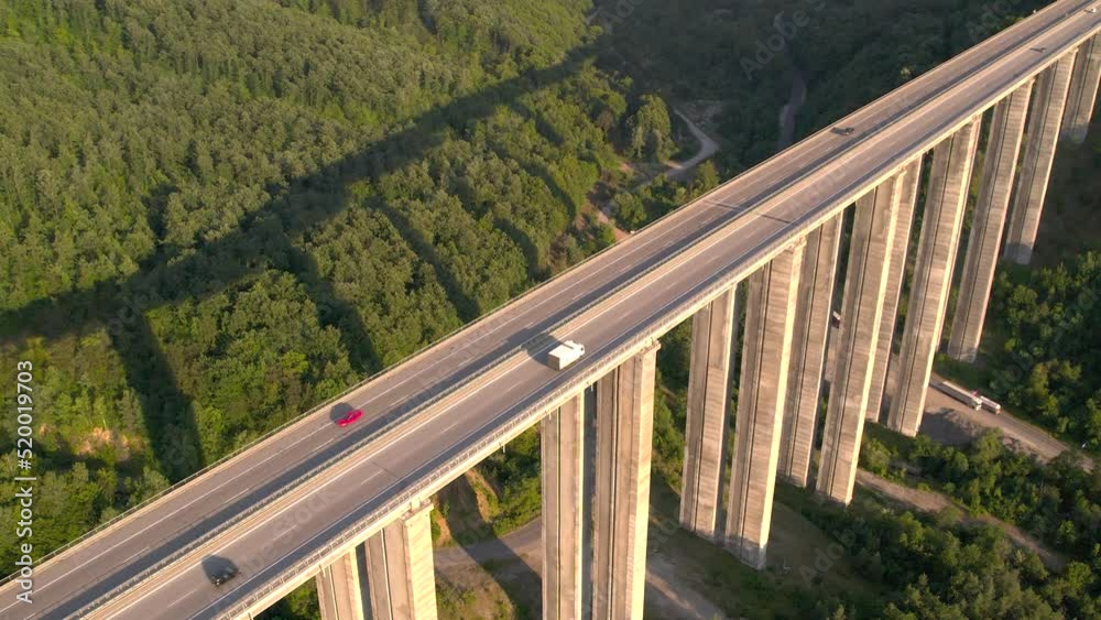Aerial Top view of summer traffic driving on a highway viaduct at sunset Aerial Top view of summer traffic driving on a highway viaduct at sunset