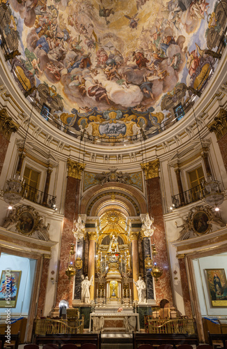 VALENCIA, SPAIN - FEBRUARY 14, 2022: The nave an fresco in cupola of the church Basilica de la Mare de Deu dels Desamparats by Antonio Palomino (1701). photo