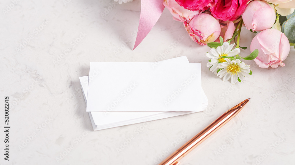 Greeting or invitation card mockup with flower and rose gold pen Greeting or invitation card mockup with flower and rose gold pen