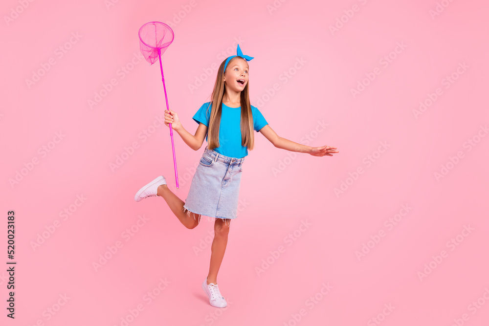 Full size photo of excited cheerful pupil arm hold insect net have good mood isolated on pink color background