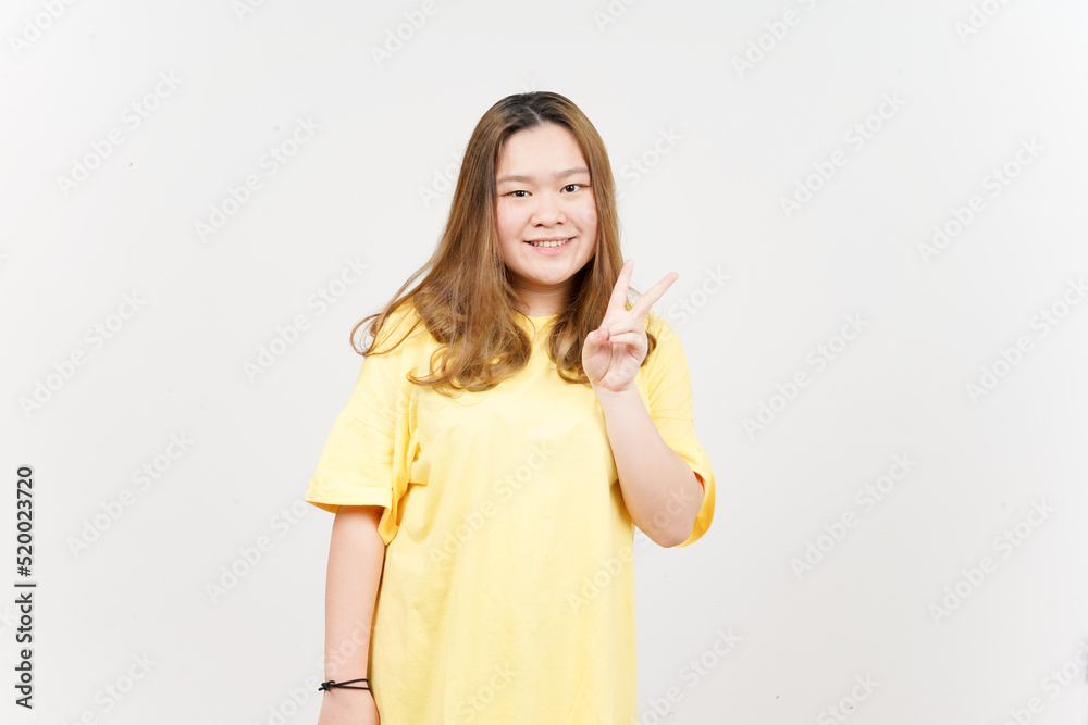 Showing Peace Sign of Beautiful Asian Woman wearing yellow T-Shirt Isolated On White Background Showing Peace Sign of Beautiful Asian Woman wearing yellow T-Shirt Isolated On White Background