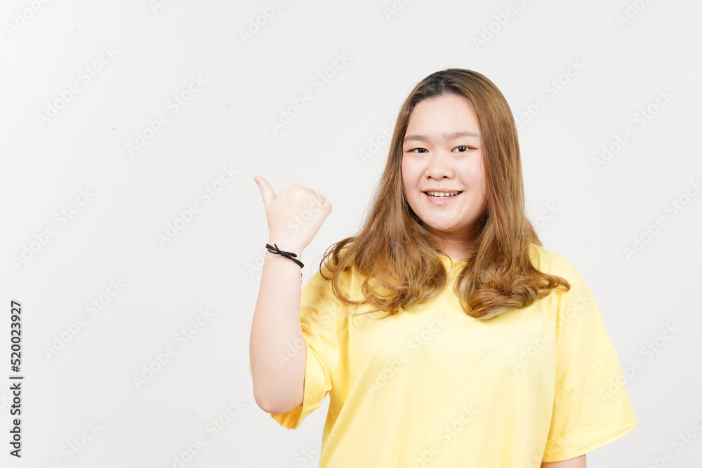 Presenting and Pointing Side Product Using Thumb of Beautiful Asian Woman wearing yellow T-Shirt Presenting and Pointing Side Product Using Thumb of Beautiful Asian Woman wearing yellow T-Shirt