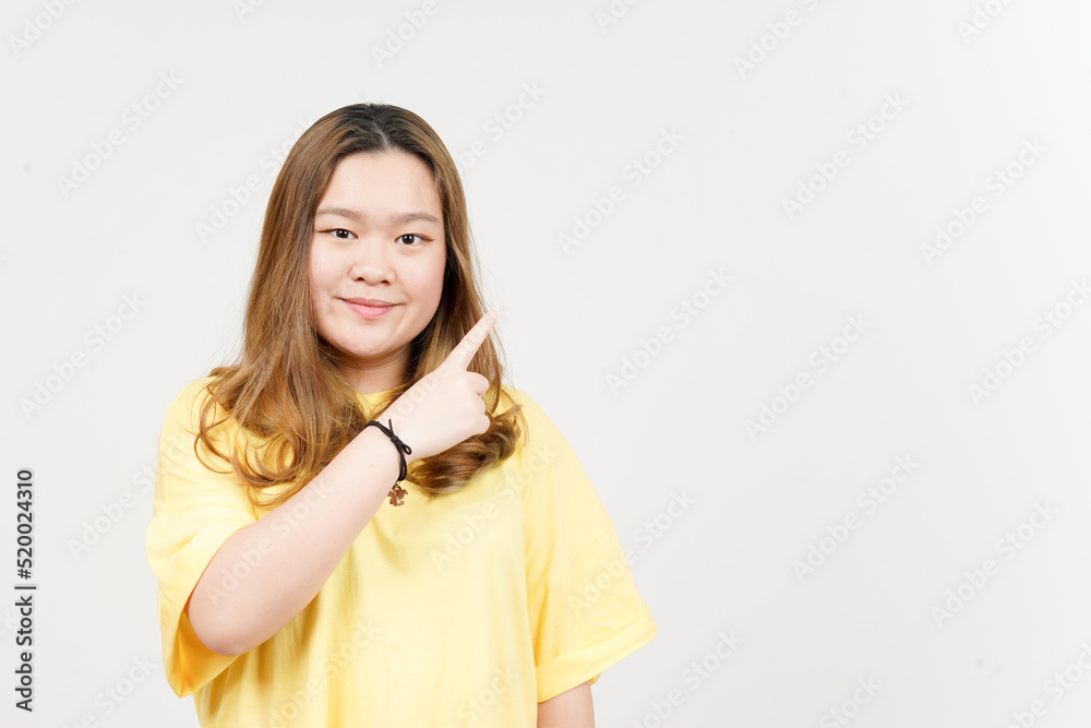 Showing Product and Pointing Side of Beautiful Asian Woman wearing yellow T-Shirt Isolated On White Showing Product and Pointing Side of Beautiful Asian Woman wearing yellow T-Shirt Isolated On White