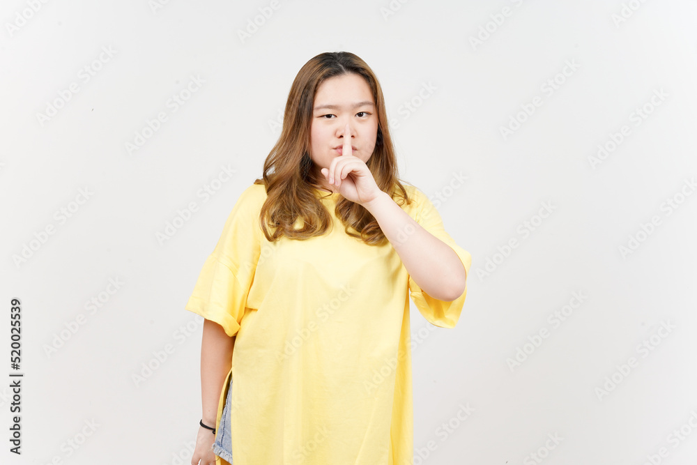 Shh Be Quiet of of Beautiful Asian Woman wearing yellow T-Shirt Isolated On White Background Shh Be Quiet of of Beautiful Asian Woman wearing yellow T-Shirt Isolated On White Background
