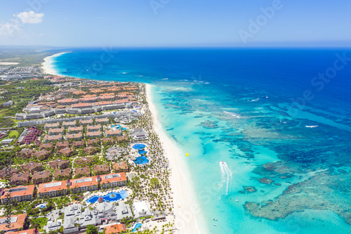 Bounty and pristine sandy shore with coconut palm trees, caribbean sea washes tropical coast. Arenda Gorda beach. Dominican Republic. Aerial view photo