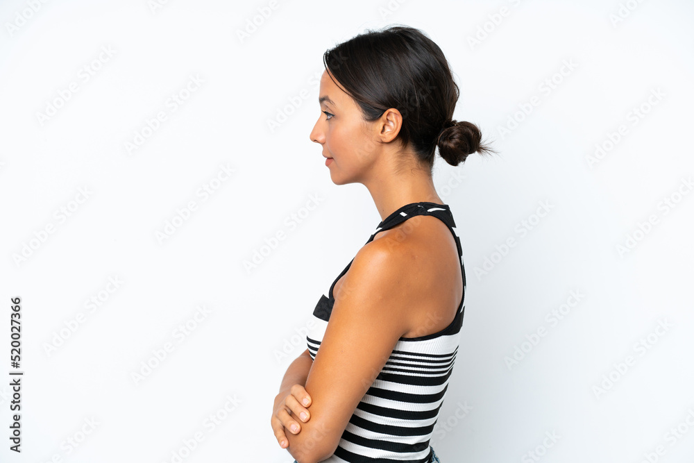 Young hispanic woman isolated on white background in lateral position Young hispanic woman isolated on white background in lateral position