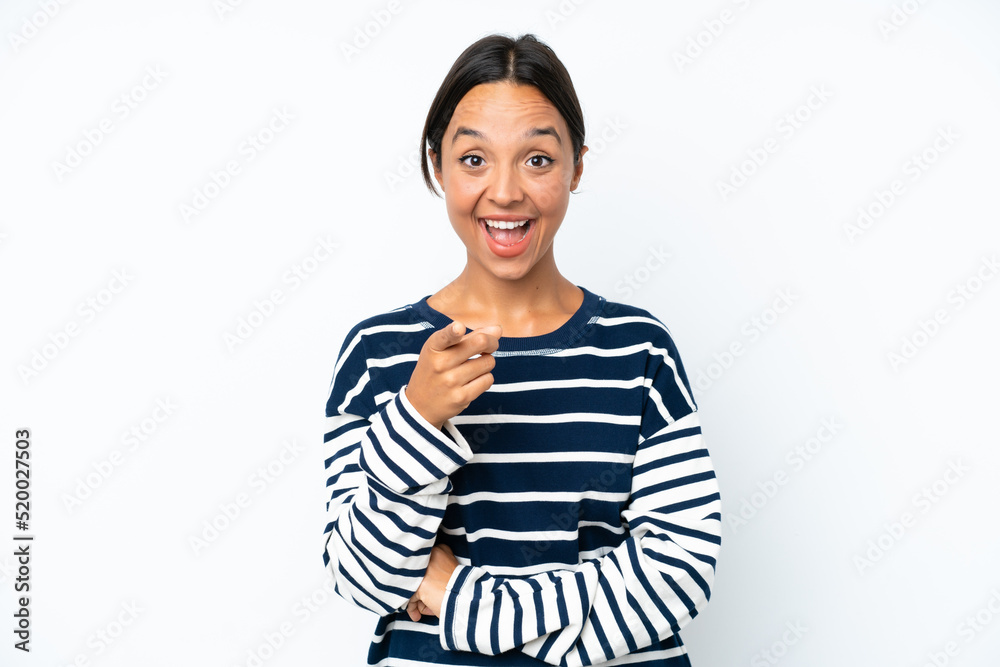 Young hispanic woman isolated on white background surprised and pointing front Young hispanic woman isolated on white background surprised and pointing front