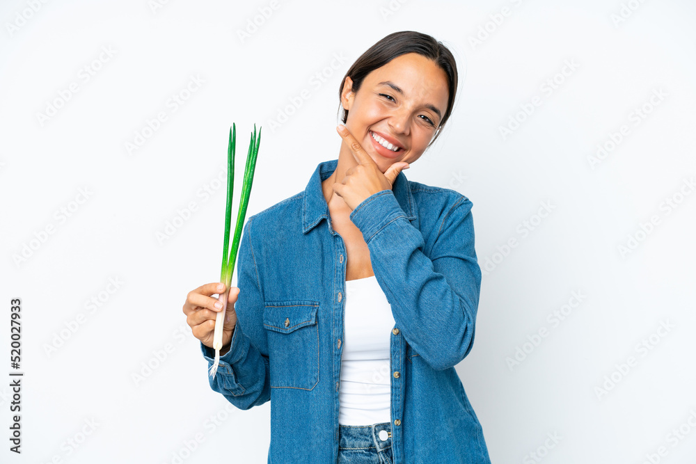 Young hispanic woman holding chive isolated on white background happy and smiling Young hispanic woman holding chive isolated on white background happy and smiling