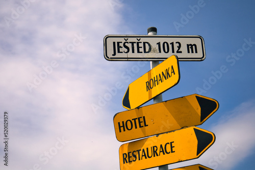 Jested Mountain peak symbol. Guide post on white and yellow background. Guide post point the way to Jested. Jested, Czech Republic. photo