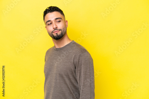 Young Arab handsome man isolated on yellow background . Portrait