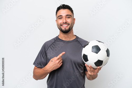 Arab young football player man isolated on white background pointing to the side to present a product