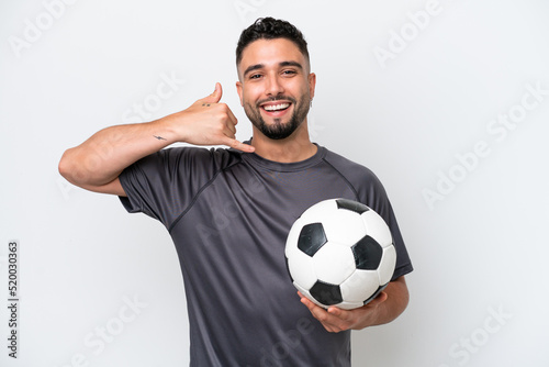 Arab young football player man isolated on white background making phone gesture. Call me back sign