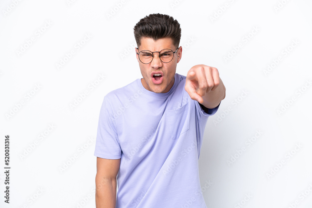 Young caucasian man isolated on white background frustrated and pointing to the front