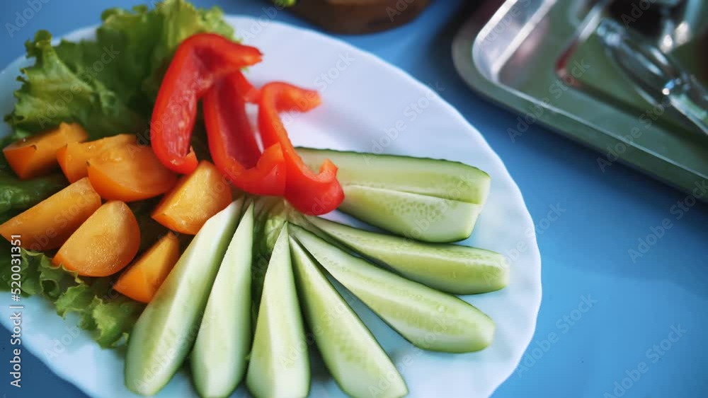 vegetable mix. cutting vegetables. close-up. Set of different fresh vegetables, such as cucumber slices, tomatoes, lettuce, bell pepper. vegetable mix. cutting vegetables. close-up. Set of different fresh vegetables, such as cucumber slices, tomatoes, lettuce, bell pepper.