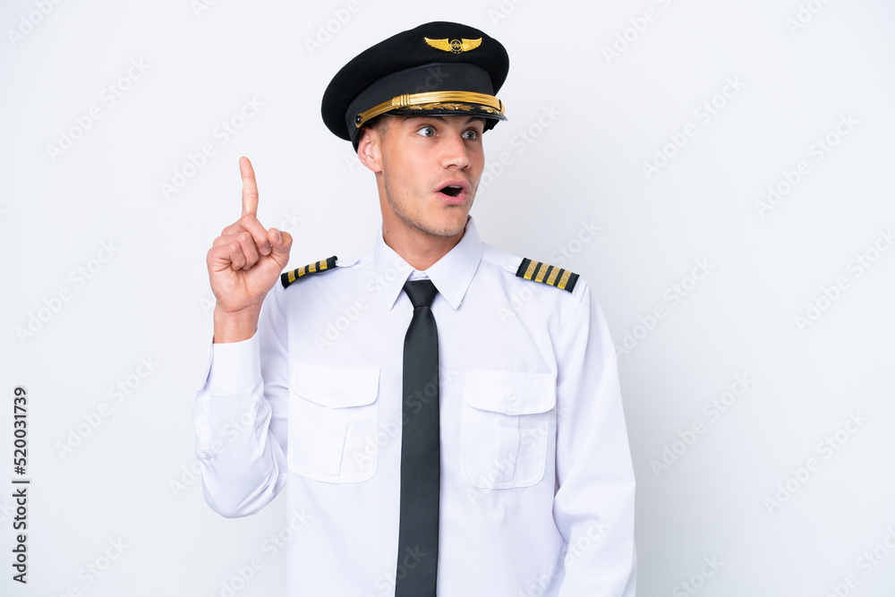 Airplane caucasian pilot isolated on white background intending to realizes the solution while lifting a finger up