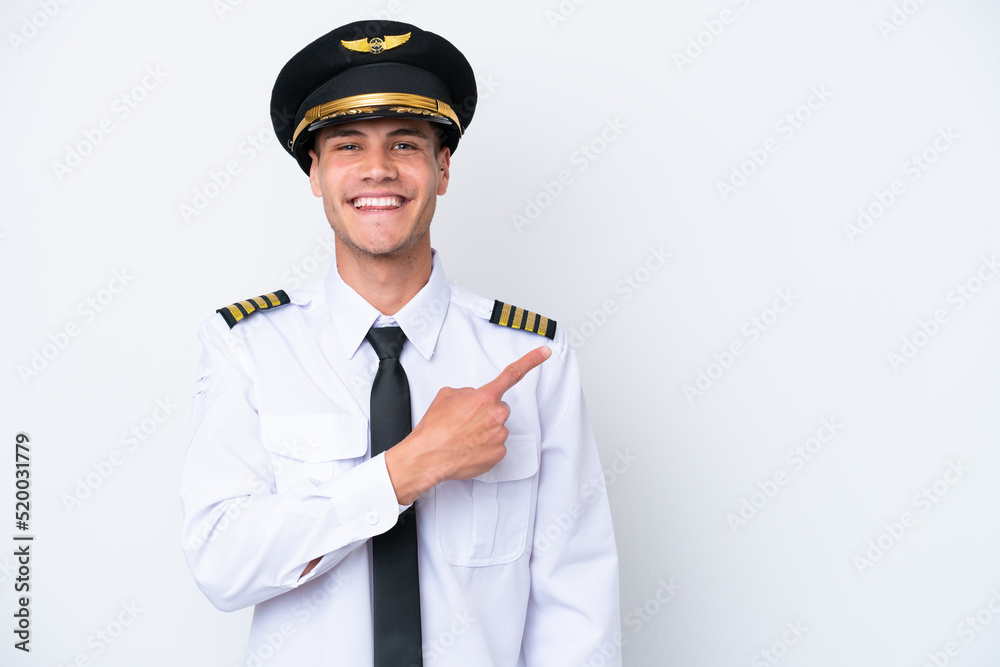 Airplane caucasian pilot isolated on white background pointing to the side to present a product Airplane caucasian pilot isolated on white background pointing to the side to present a product