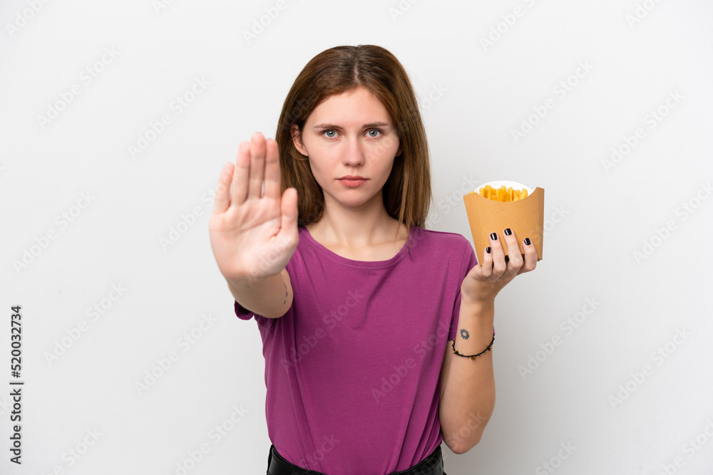 Young English woman holding fried chips isolated on white background making stop gesture Young English woman holding fried chips isolated on white background making stop gesture