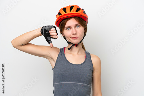 Young cyclist English woman isolated on white background showing thumb down with negative expression © luismolinero