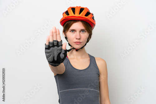 Young cyclist English woman isolated on white background making stop gesture