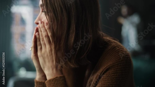 Portrait of Crying Woman Covering Her Face with Hands, being Harrased and Bullied by Violent Partner. Couple Arguing, Fighting, Domestic Abuse, Toxic Masculinity. Rack Focus with Boyfriend Screaming photo