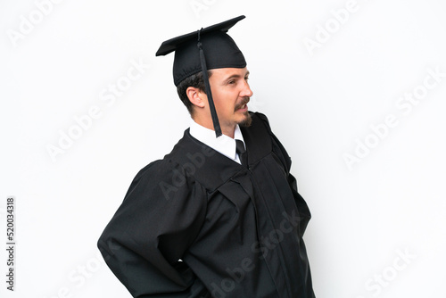 Young university graduate man isolated on white background suffering from backache for having made an effort