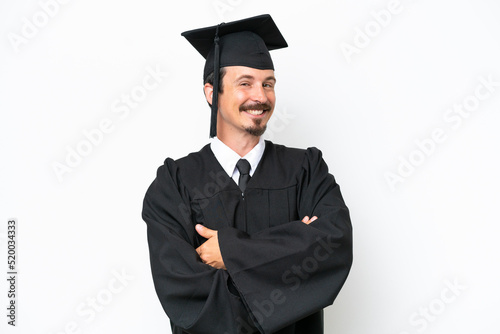 Young university graduate man isolated on white background with arms crossed and looking forward