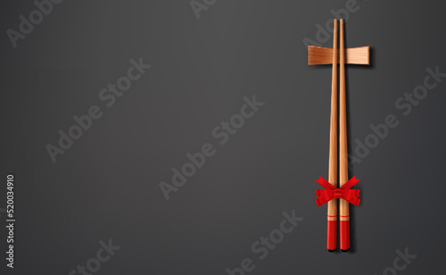 Chopsticks and chopstick holder, decorated with red bow lie on a gray background.