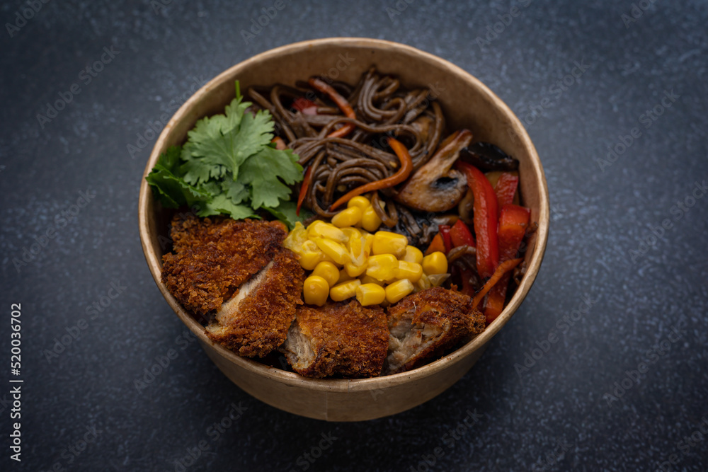 Fototapeta premium Japanese ramen soup with noodles, meat in a cardboard disposable plate 