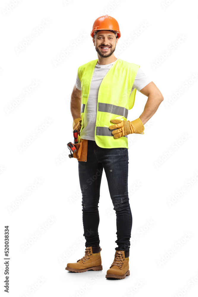 Full length portrait of a construction worker wearing a tool belt and smiling at camera Full length portrait of a construction worker wearing a tool belt and smiling at camera