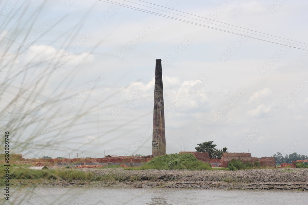 Fototapeta premium Old brick factory chimney, brick factory landscape