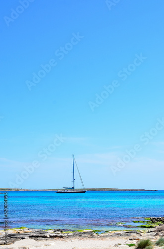 sailing yacht anchored offshore in the mediterranean sea. vertical photo
