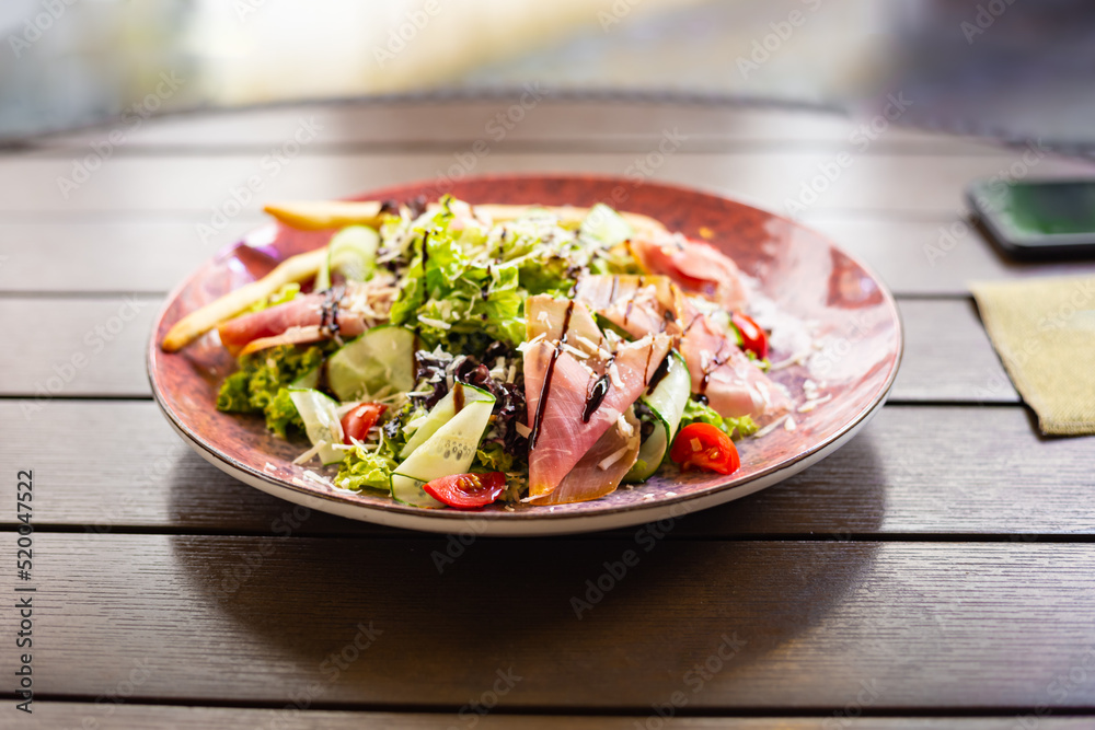 Vegetables and prosciutto crudo salad.Restaurant meat fresh salad close up. Mediterranean seasonal side dish. Vegetables and prosciutto crudo salad.Restaurant meat fresh salad close up. Mediterranean seasonal side dish.