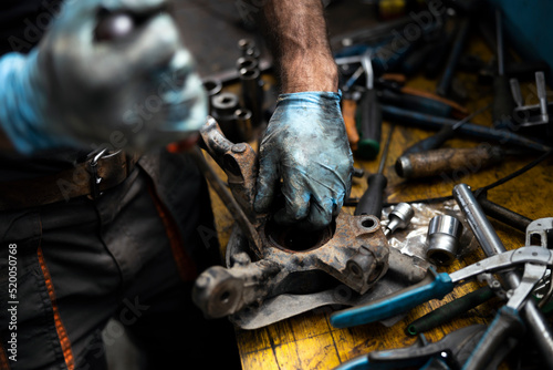 Mechanic Replacing a Car Wheel Bearing in Garage