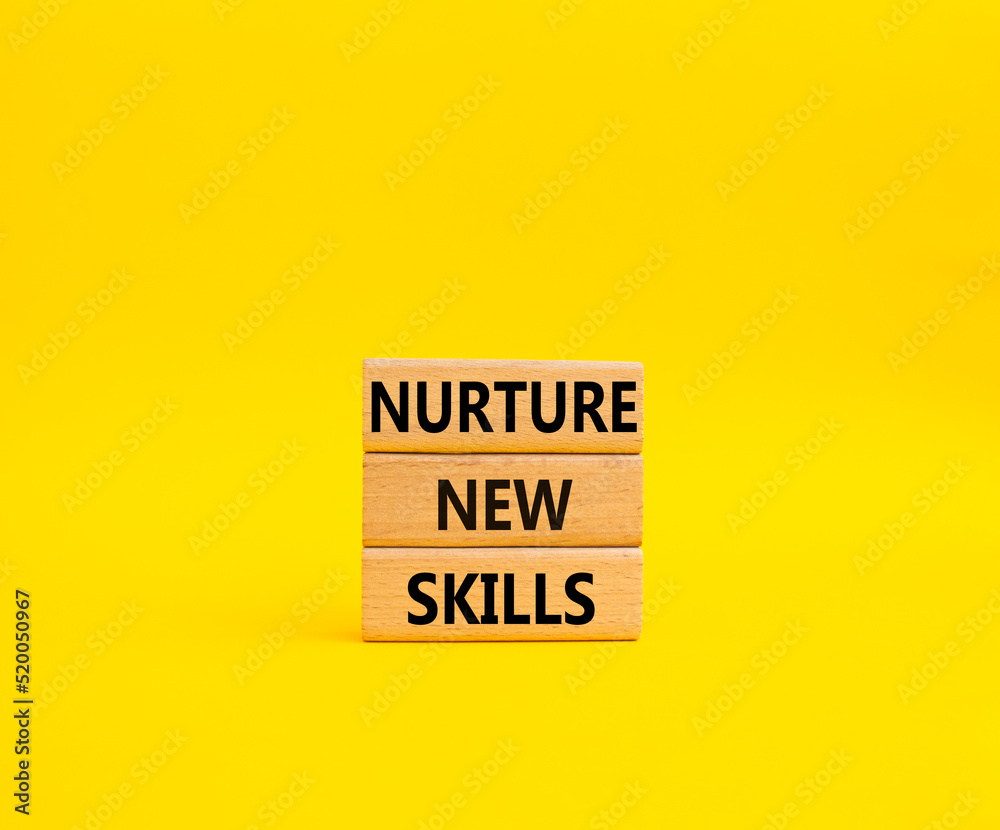 Nurture new skills symbol. Concept words Nurture new skills on wooden blocks. Beautiful yellow background. Business and Nurture new skills concept. Copy space