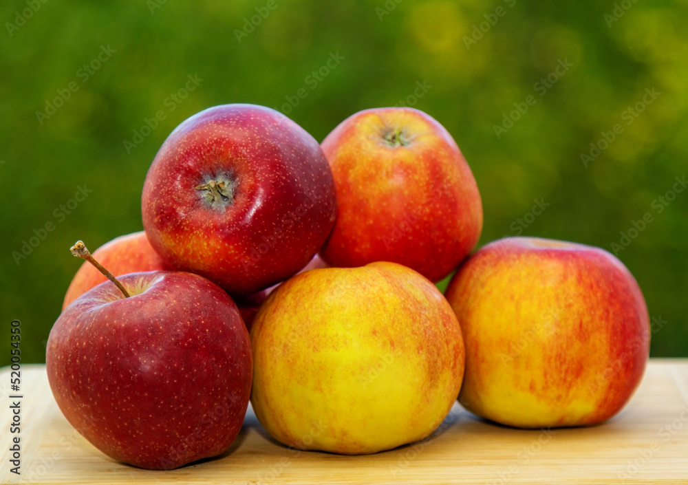 Fresh red apples on a wooden table, on a natural background. Apples from the new harvest, farmers market. Fresh red apples on a wooden table, on a natural background. Apples from the new harvest, farmers market.