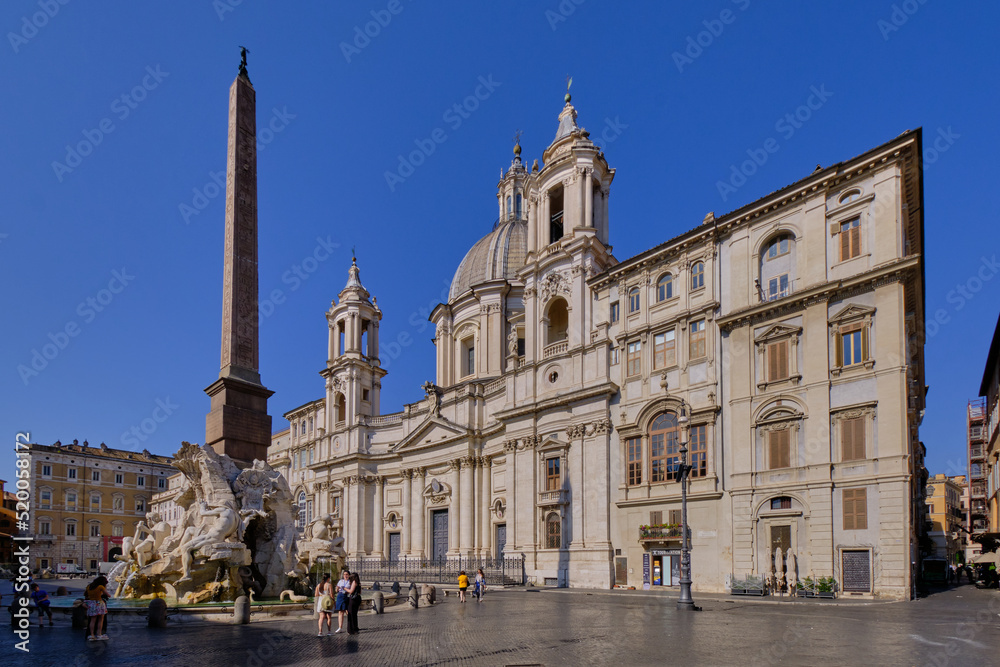 The facade of the church of S. Agnese in Agone and Fontana dei Quattro Fiumi baroque styled fountain in Piazza Navona, Rome